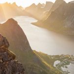 Norway Renewable - The sun is setting over a mountain range and lake