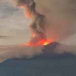 Jeju Lava - A large plume of smoke rises from the top of a mountain